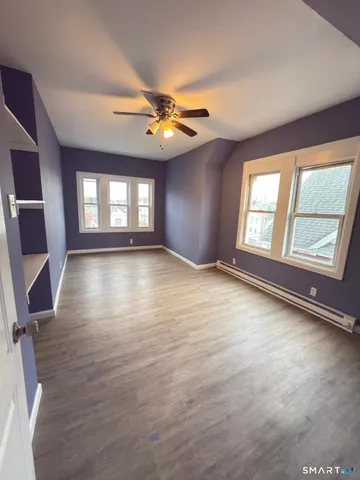 wooden floor in an empty room with a window