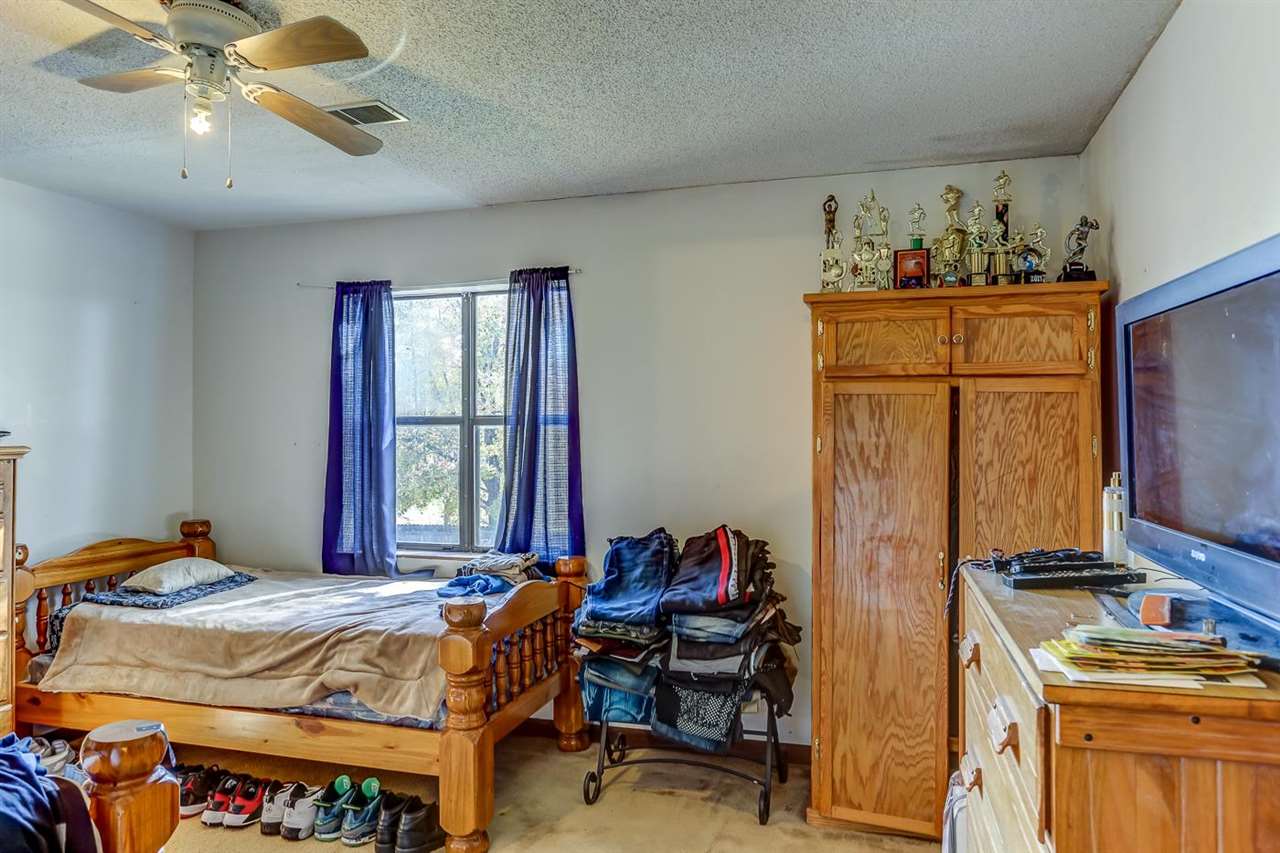 10 Windsor Road Memphis, TN 38109 - Photo 15 of 25 a bedroom with a bed and a chandelier