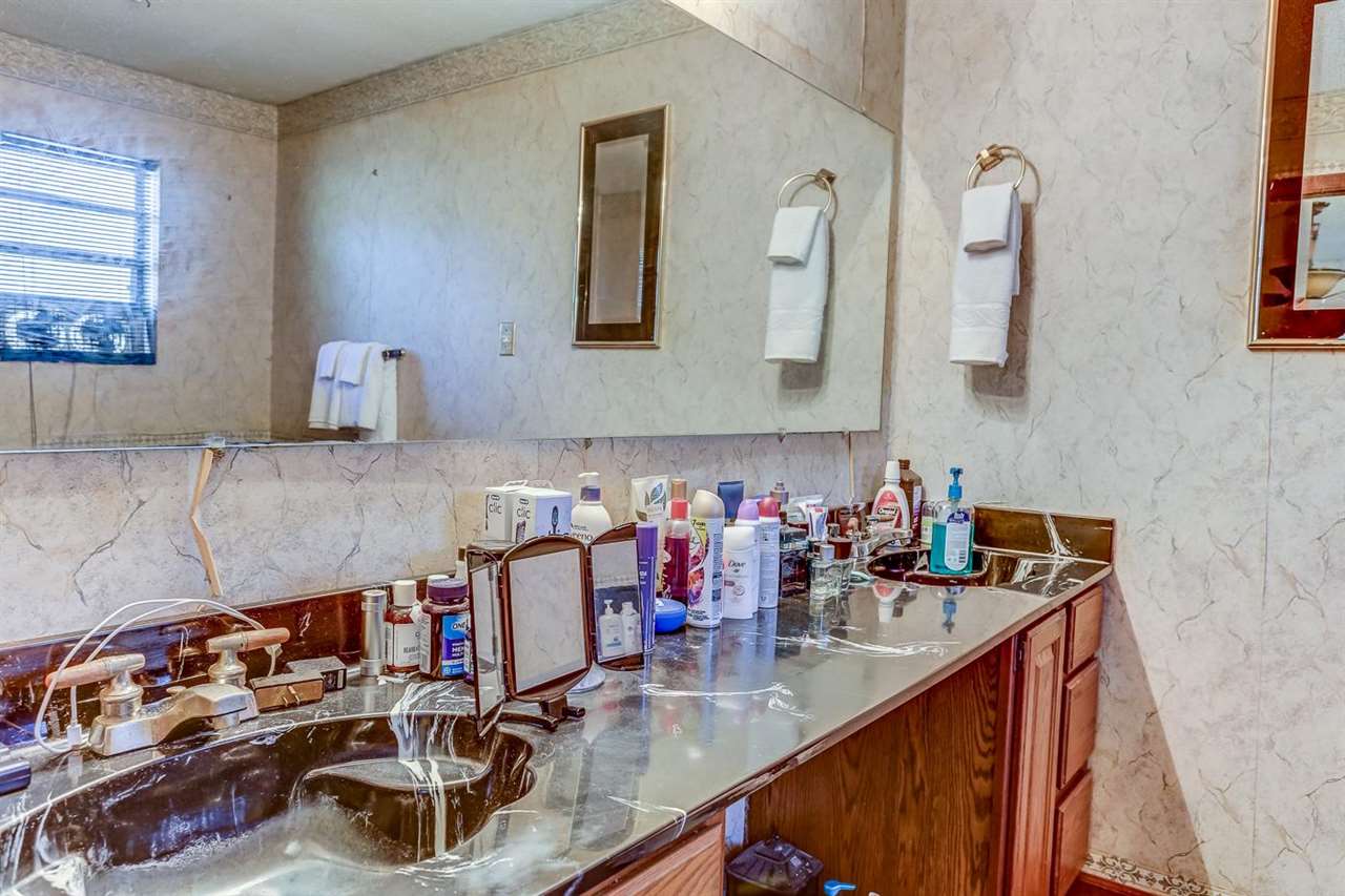 10 Windsor Road Memphis, TN 38109 - Photo 17 of 25 a bathroom with sink and mirror