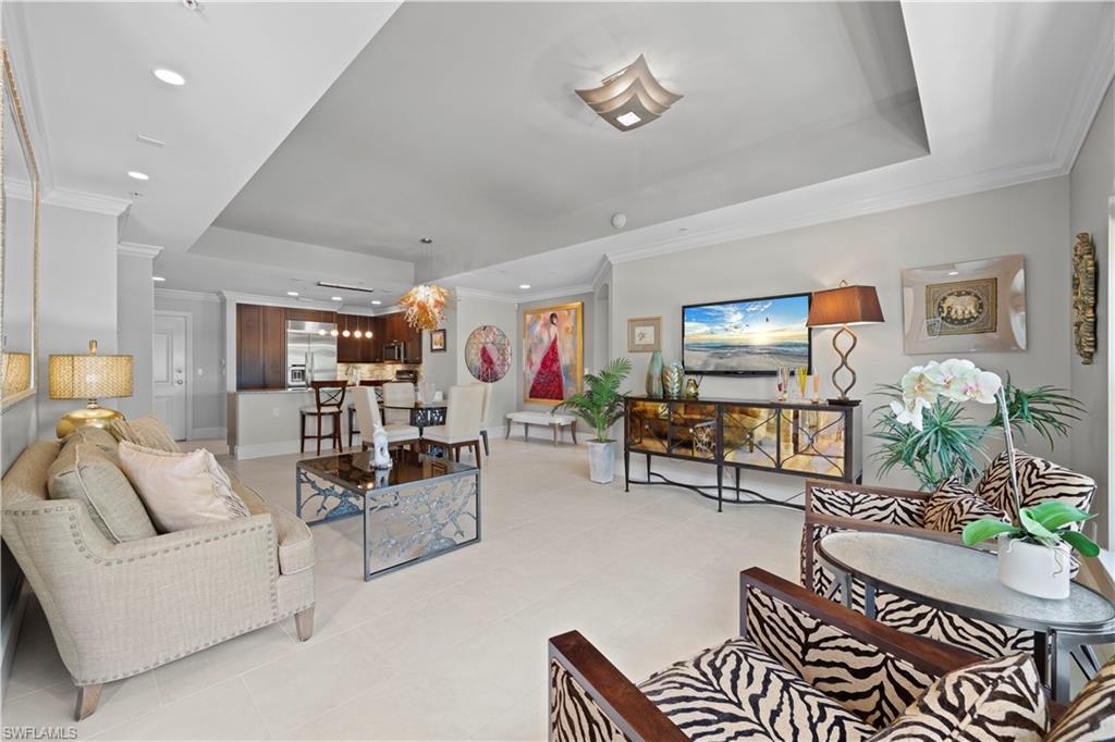 9115 Strada Place, Unit 5314 Naples, FL 34108 - Photo 6 of 44 a living room with furniture and a flat screen tv