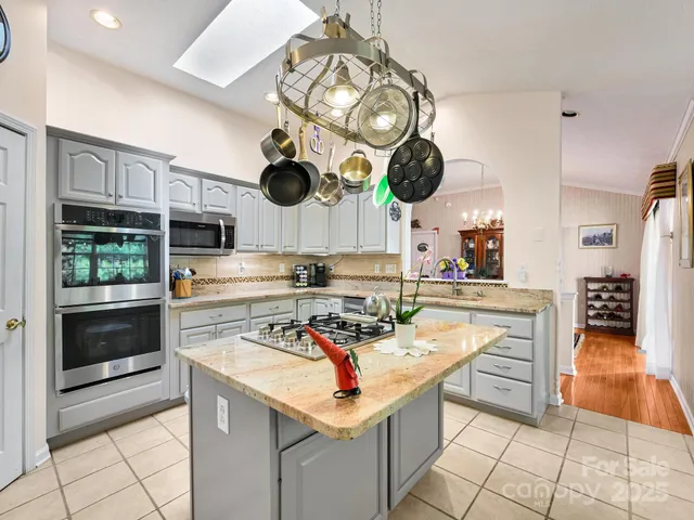 a kitchen with a stove and a wooden floor