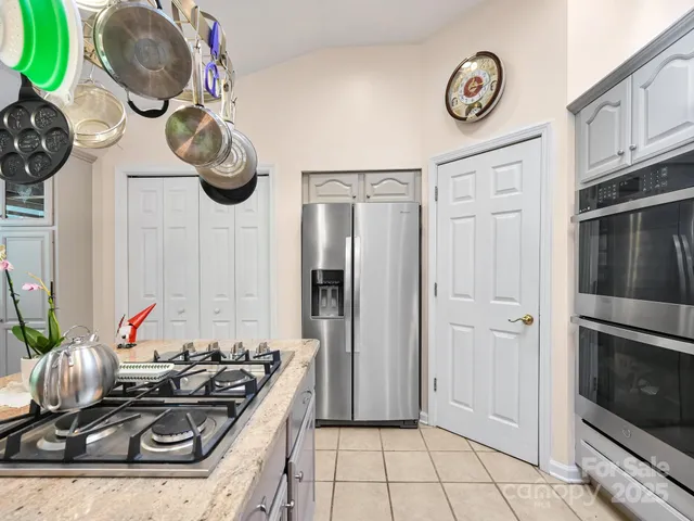 a dining room with furniture a chandelier and wooden floor