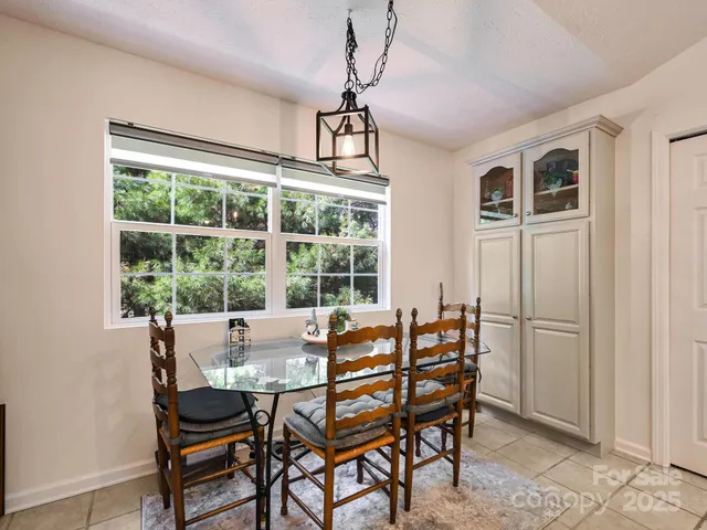 a dining room with furniture and window
