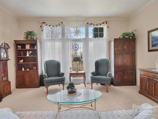 a living room with furniture gym equipment and a large window