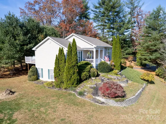 a view of a house with yard and sitting area