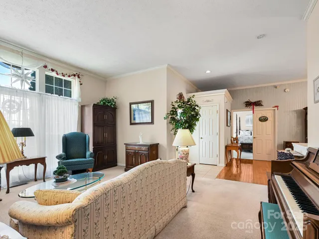 a living room with furniture and a lamp