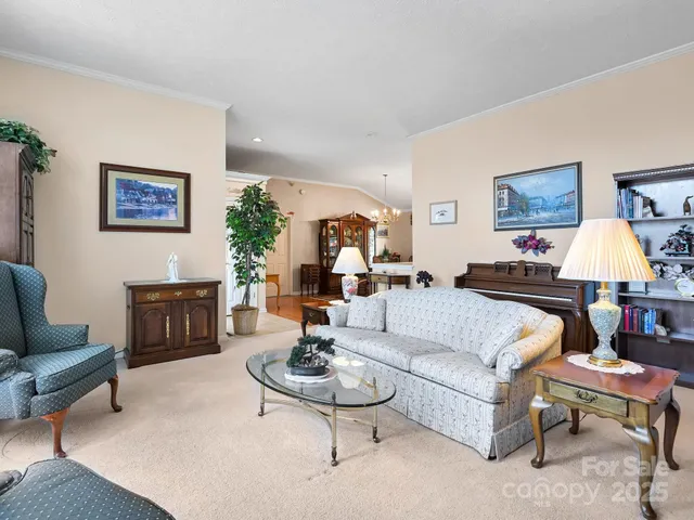 a living room with fireplace furniture and a large window