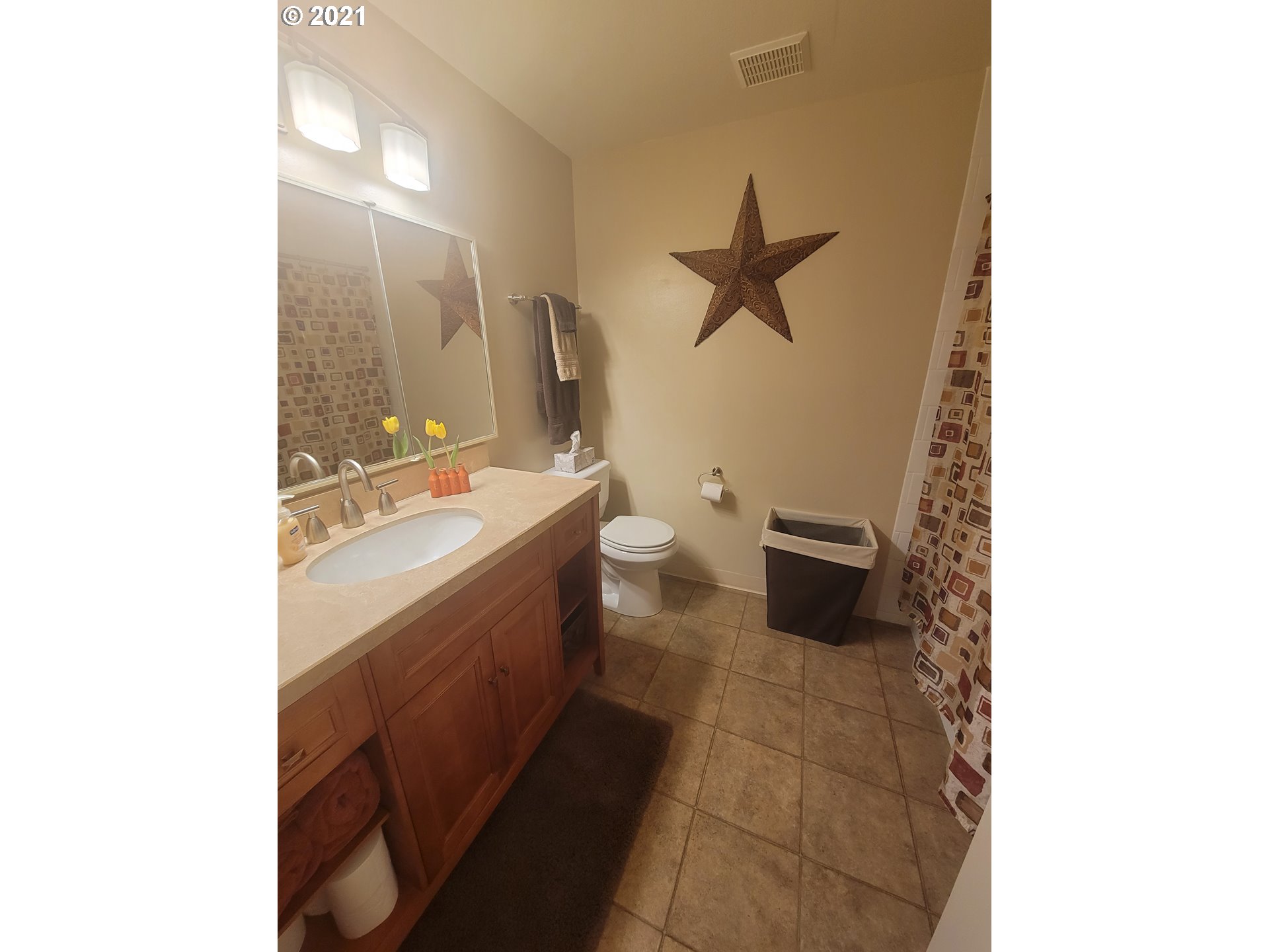 1902 Southwest Perkins Avenue Pendleton, OR 97801 - Photo 18 of 32 a bathroom with a double vanity sink a toilet and a mirror