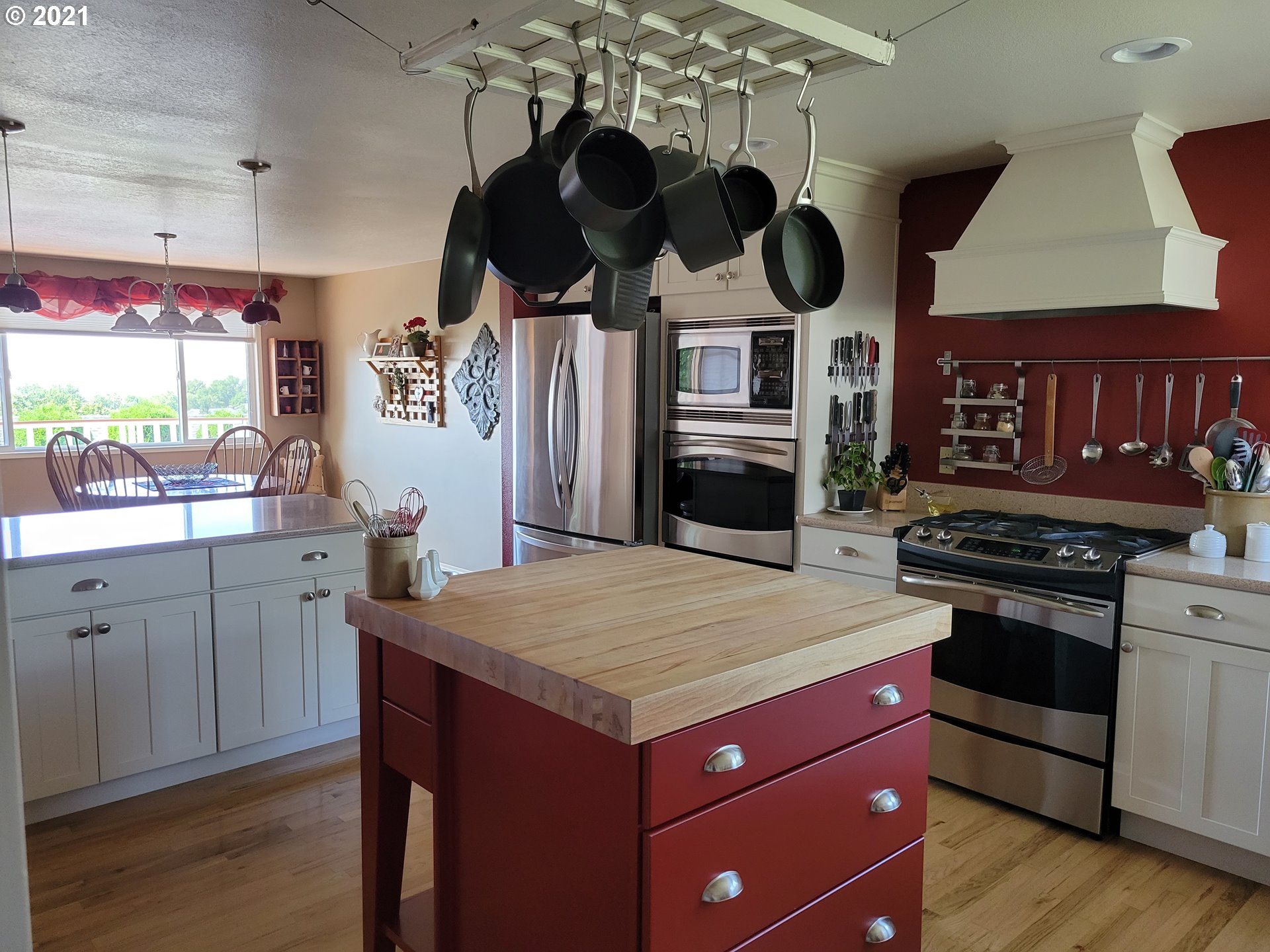 1902 Southwest Perkins Avenue Pendleton, OR 97801 - Photo 7 of 32 a kitchen with stainless steel appliances granite countertop a stove and a wooden floors