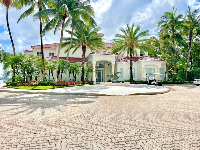a view of a house with a swimming pool and a large tree with potted plants