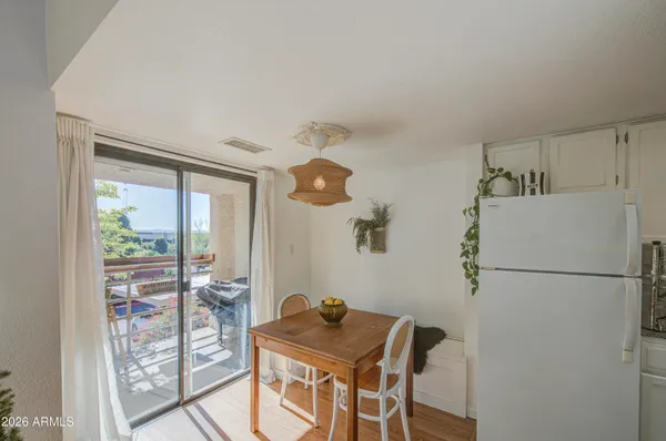 a kitchen with a refrigerator and a table