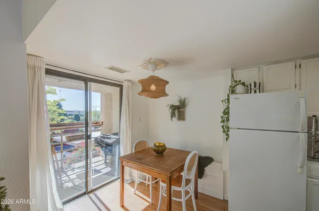 a kitchen with a refrigerator and a table