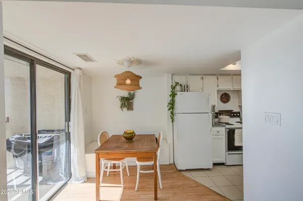 a room with furniture a rug and white walls