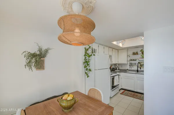 a kitchen with stainless steel appliances granite countertop a sink a stove white refrigerator and cabinets