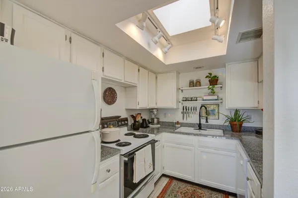 a kitchen with stainless steel appliances a sink stove and refrigerator