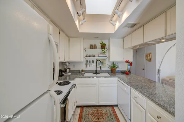 a kitchen with a sink a stove and cabinets