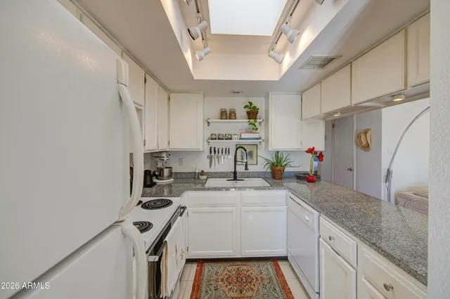 a kitchen with a sink a stove and cabinets