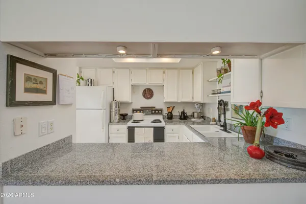 a kitchen with a refrigerator and a sink