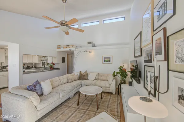 a living room with furniture and a chandelier