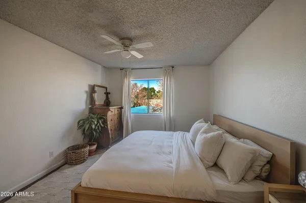 a bedroom with furniture and a window