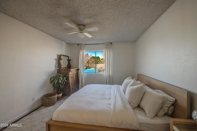 a bedroom with furniture and a window