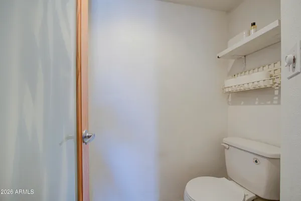 a white toilet sitting next to a shower curtain