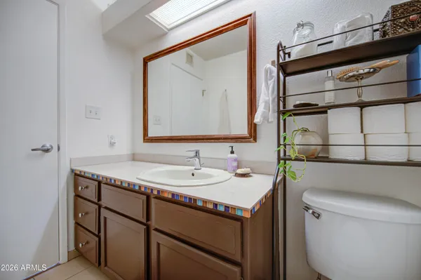 a bathroom with a sink a toilet and mirror
