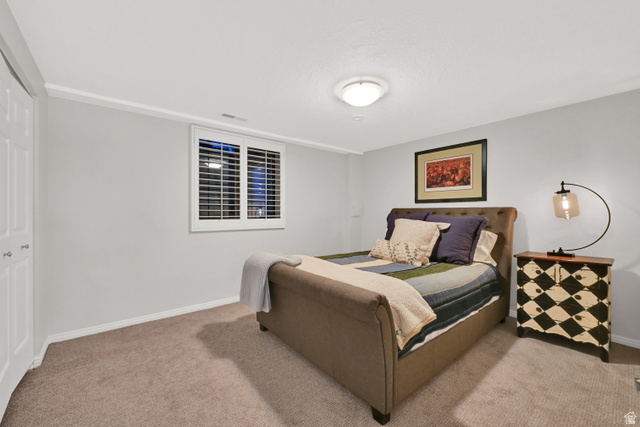 2314 Ridgewood Way Bountiful, UT 84010 - Photo 20 of 26 Interior space featuring neutral wall paint, white plantation shutters, white bi-fold closet doors, and carpet flooring