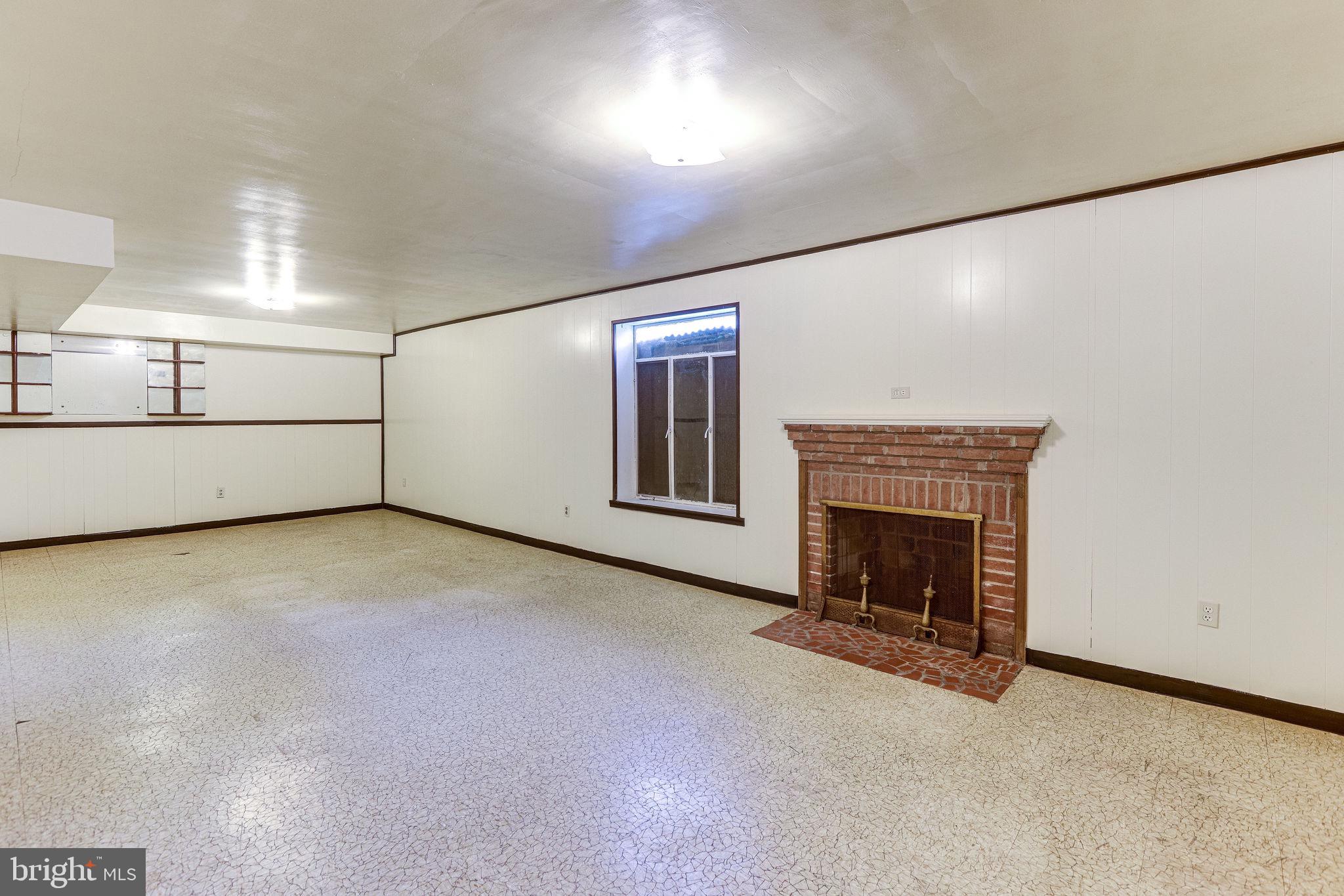 1212 Ballard Street Silver Spring, MD 20910 - Photo 27 of 41 Basement family room has wood fireplace.