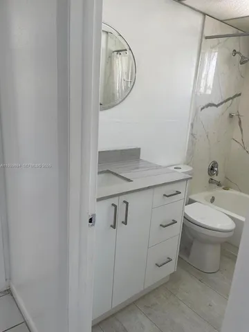 a bathroom with a toilet a sink and a mirror