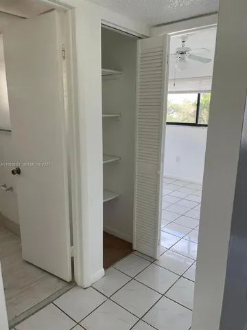 a view of a hallway and closet in a room