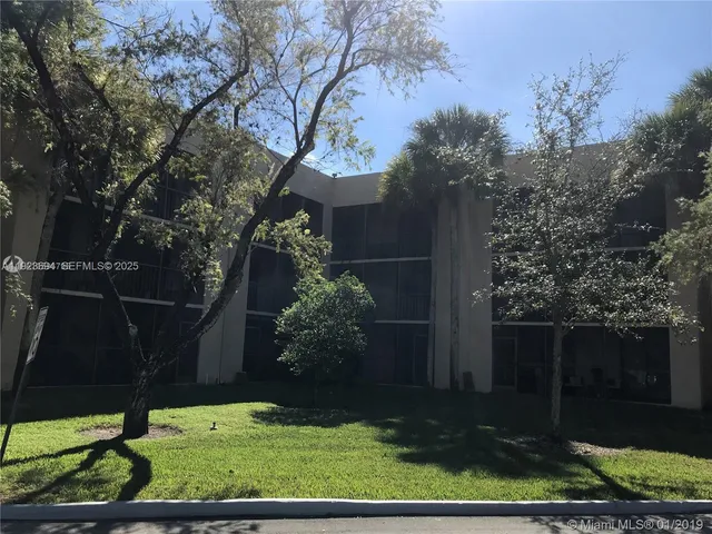 a view of a park with large trees