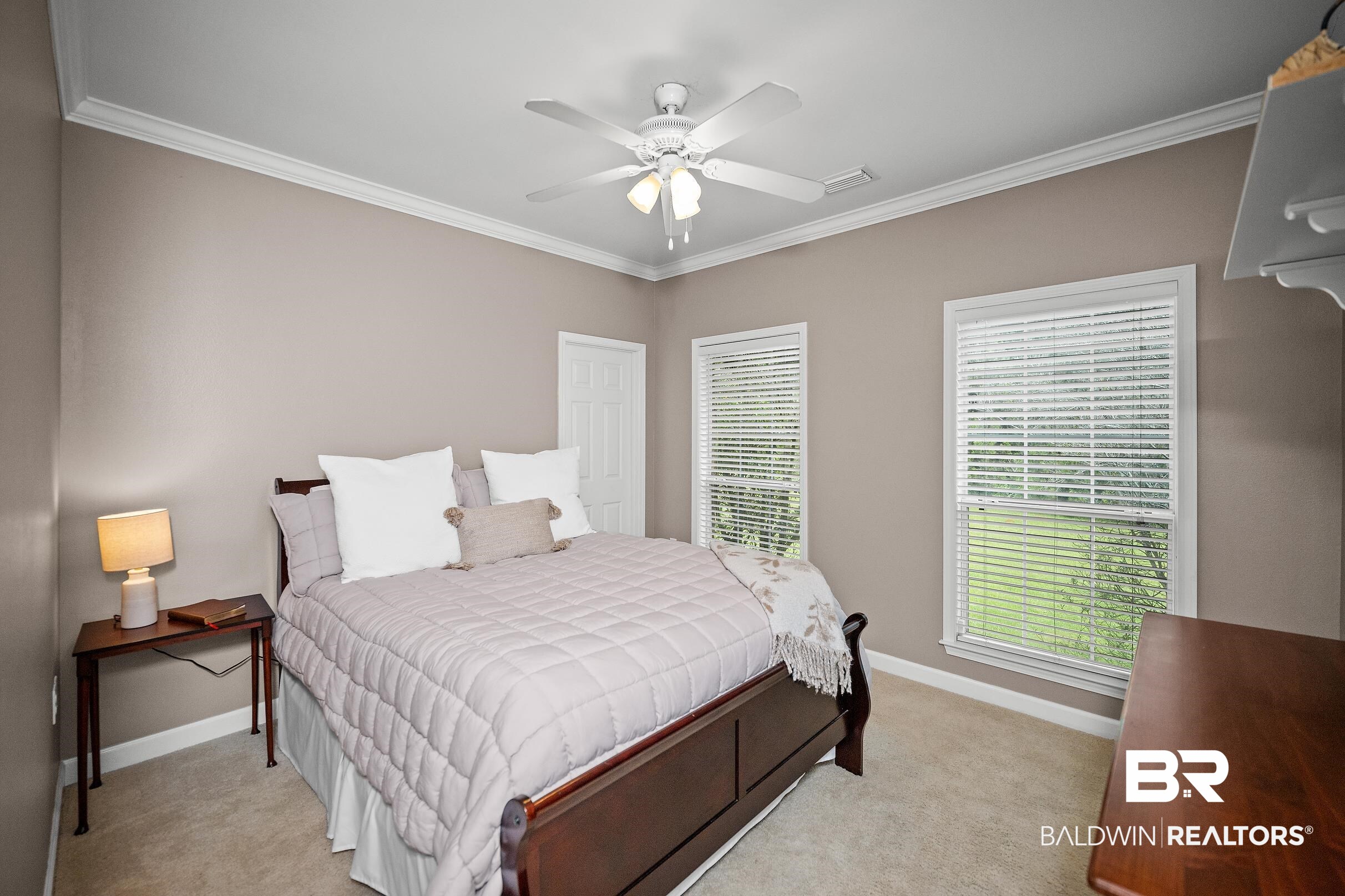197 Morning Ridge Road Monroeville, AL 36460 - Photo 34 of 51 Carpeted room featuring a ceiling fan with integrated lighting, crown molding, and two windows with blinds
