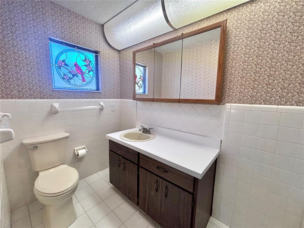 324 Alemander Avenue DeBary, FL 32713 - Photo 22 of 40 a bathroom with a sink mirror vanity and toilet