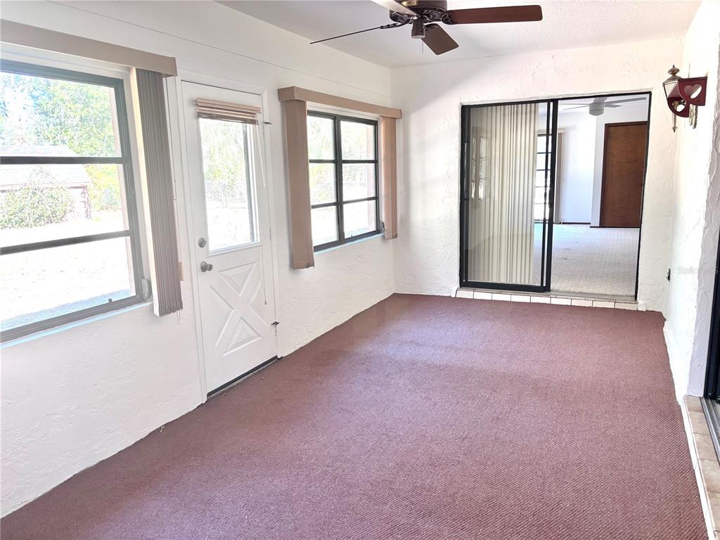 324 Alemander Avenue DeBary, FL 32713 - Photo 27 of 40 an empty room with windows and ceiling fan