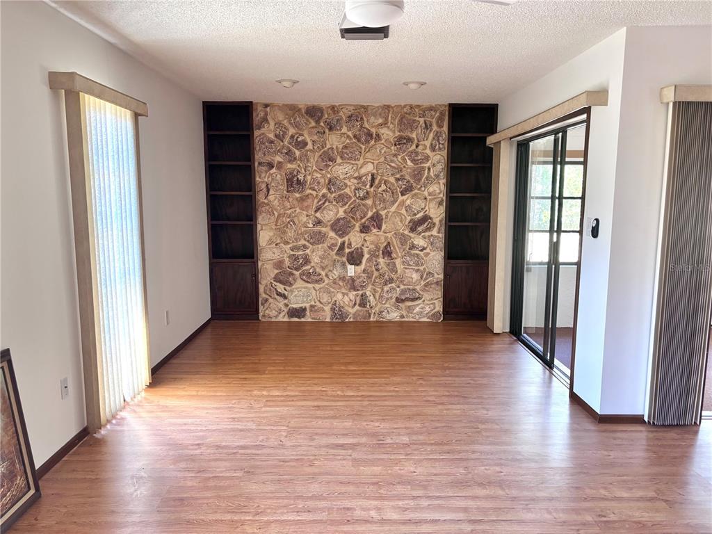 324 Alemander Avenue DeBary, FL 32713 - Photo 4 of 40 an empty room with wooden floor and windows