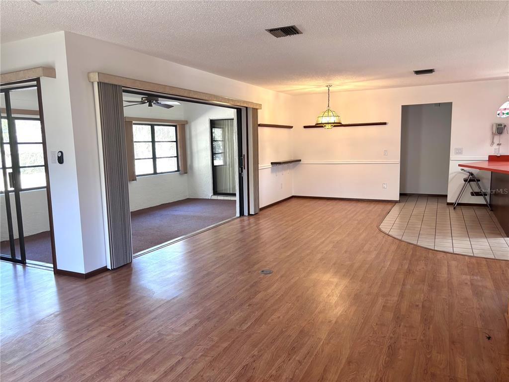 324 Alemander Avenue DeBary, FL 32713 - Photo 10 of 40 wooden floor in an empty room with a window