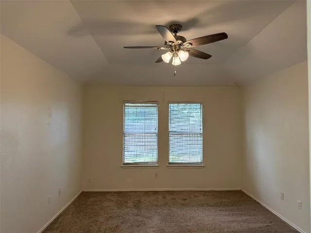 a view of empty room with window and wooden floor
