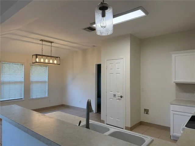 an empty room with a empty space and a chandelier fan