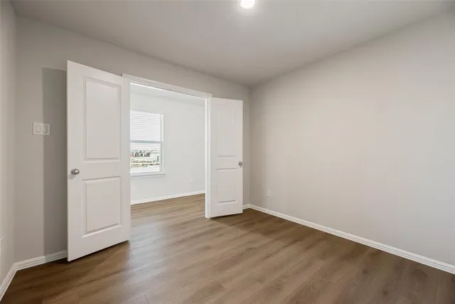 an empty room with wooden floor