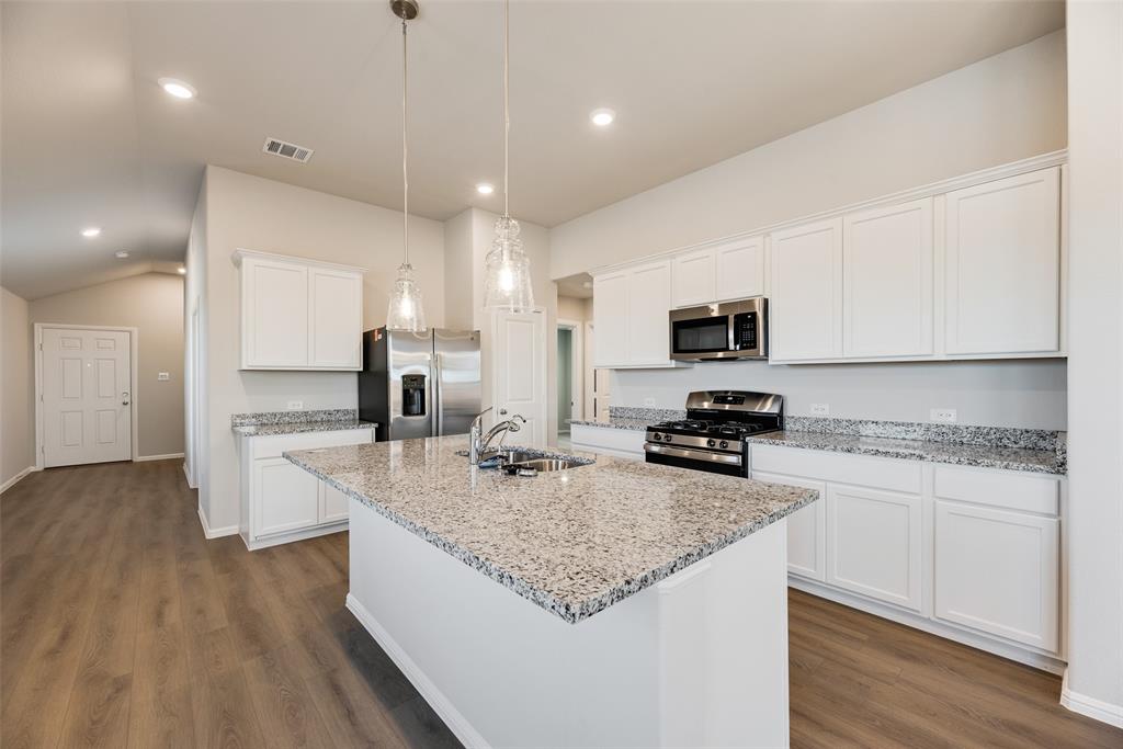 14127 Bacton Road Pilot Point, TX 76258 - Photo 13 of 18 a kitchen with sink stove microwave and refrigerator