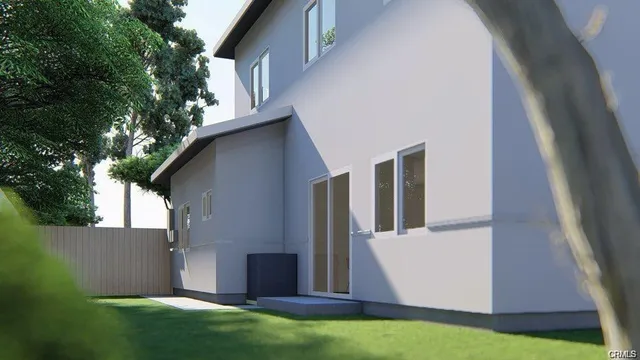 a view of a white house with a yard