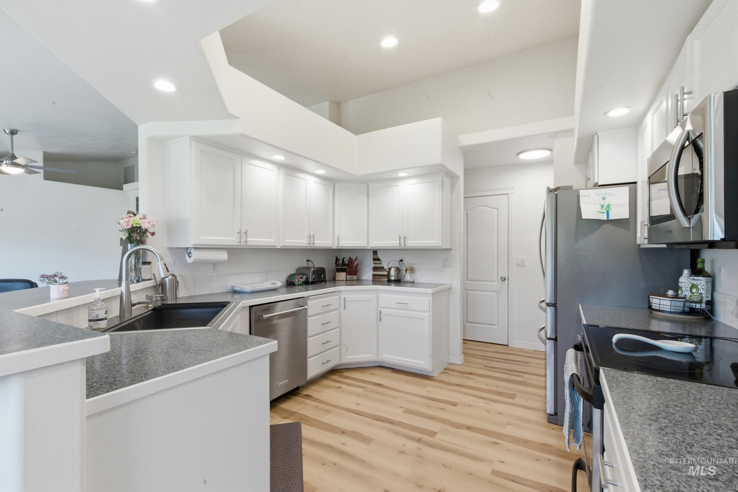 7781 Redmon Road Caldwell, ID 83607 - Photo 29 of 50 Open-concept kitchen and dining area featuring light wood-finish flooring
