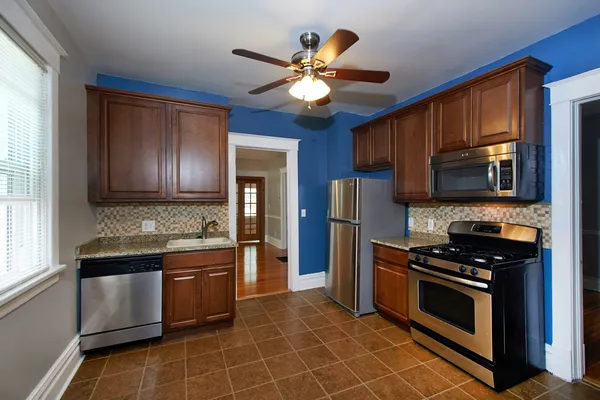 a kitchen with stainless steel appliances a stove microwave and refrigerator