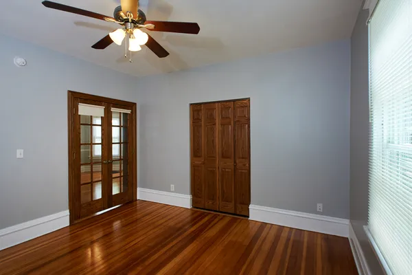 wooden floor in an empty room with a window