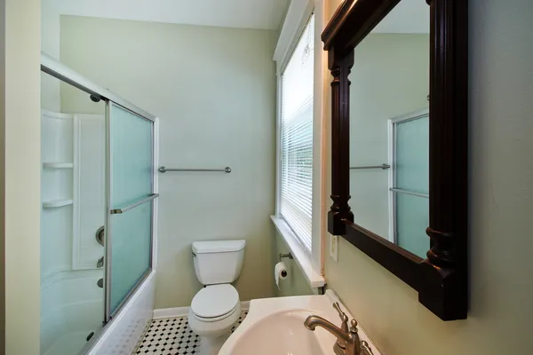 a bathroom with a toilet and a shower