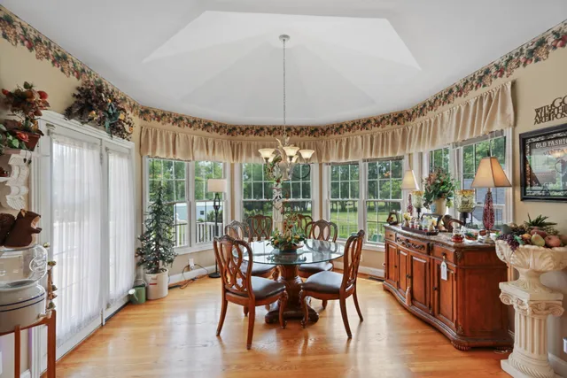 a bedroom with furniture a flat screen tv and a chandelier