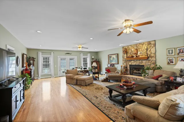 a living room with furniture a fireplace and a flat screen tv