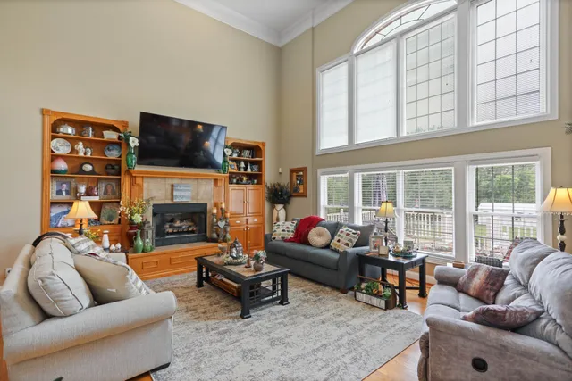 a living room with furniture fireplace and a flat screen tv