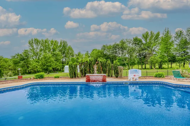 a front view of a house with yard and outdoor seating